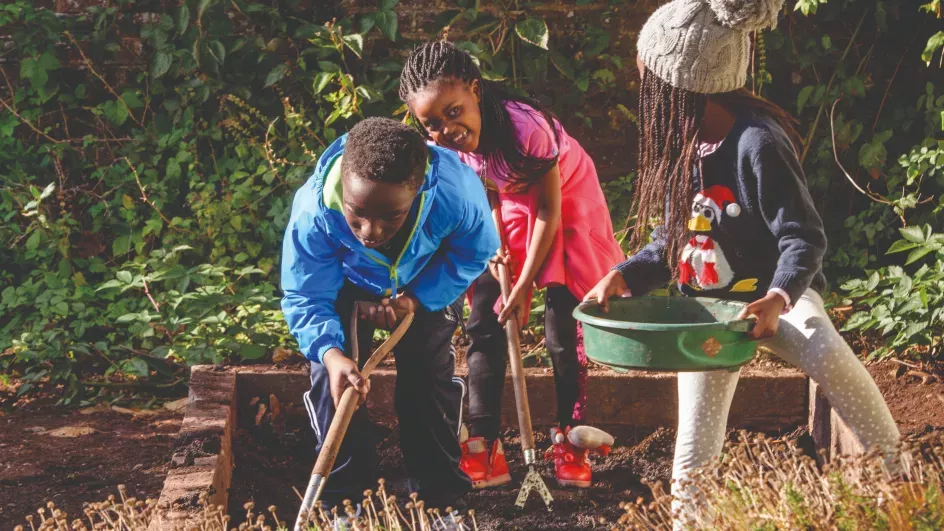 Children digging in a garden