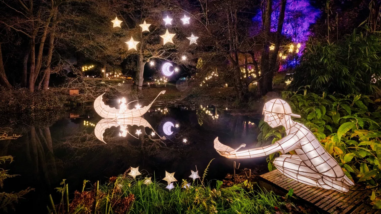 Moon, stars, boat and boy lanterns on a lake at Wakehurst