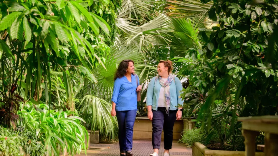 Friends walking through Kew Gardens 