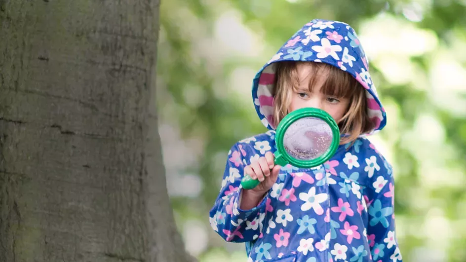 Kid with magnifying glass