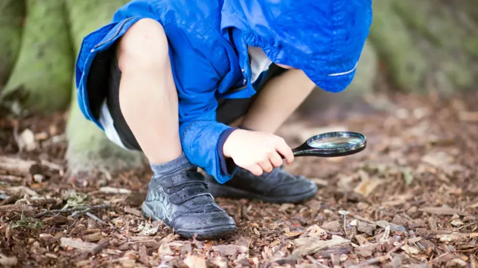 Kid with a magnifying glass