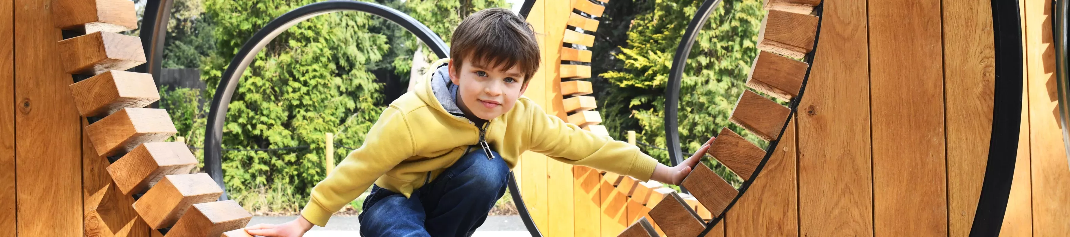 A boy playing in the Children's Garden at Kew