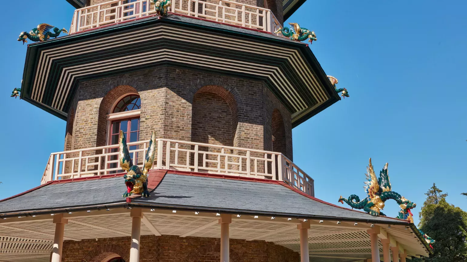 Low angle shot of the Great Pagoda with a blue sky in the background. Dragons can be seen adorning the outside of the building. 