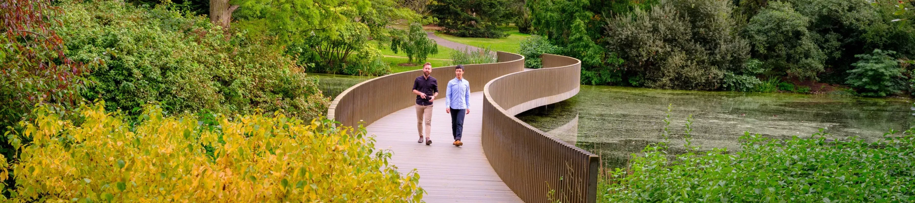 Visitors walk over the Lake Crossing