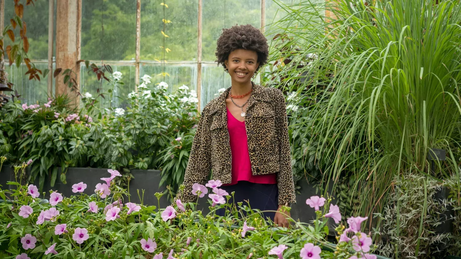 Woman standing amongst plants at Kew