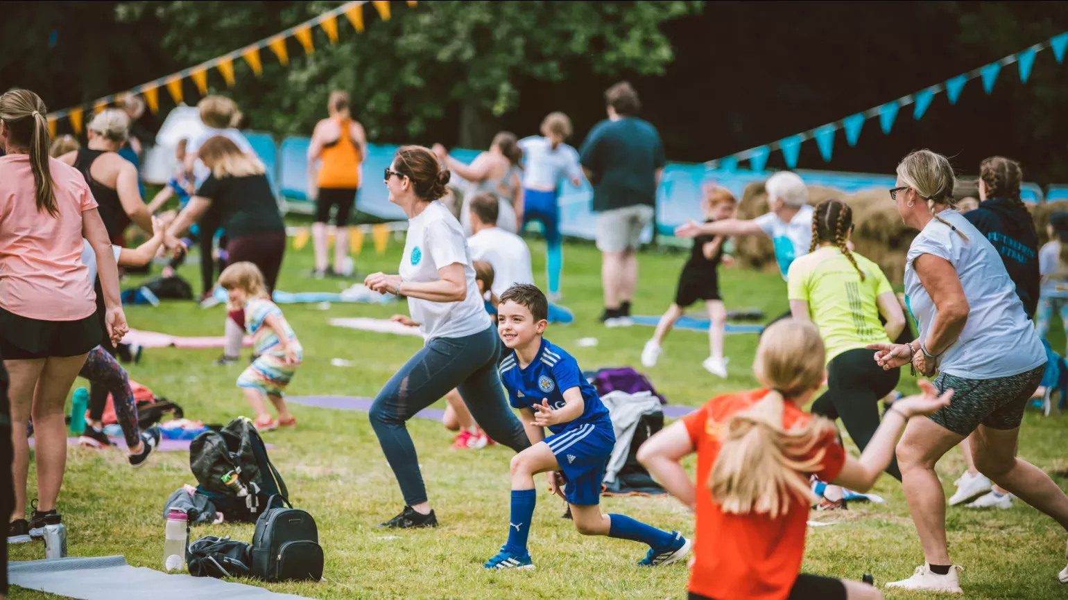 People doing lunges in a decorated field