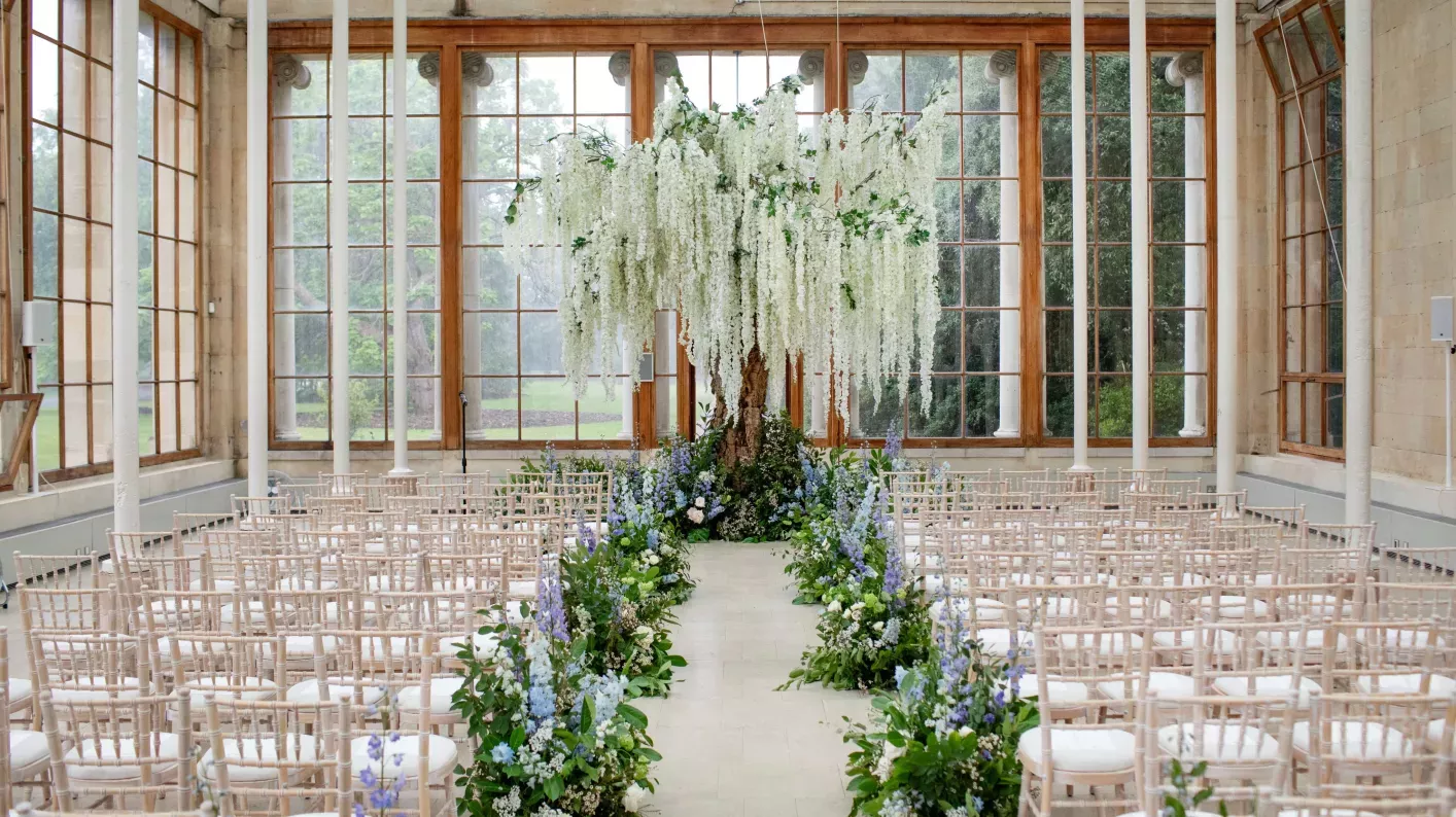 Conservatory decorated for a wedding with a huge hanging display of white wisteria