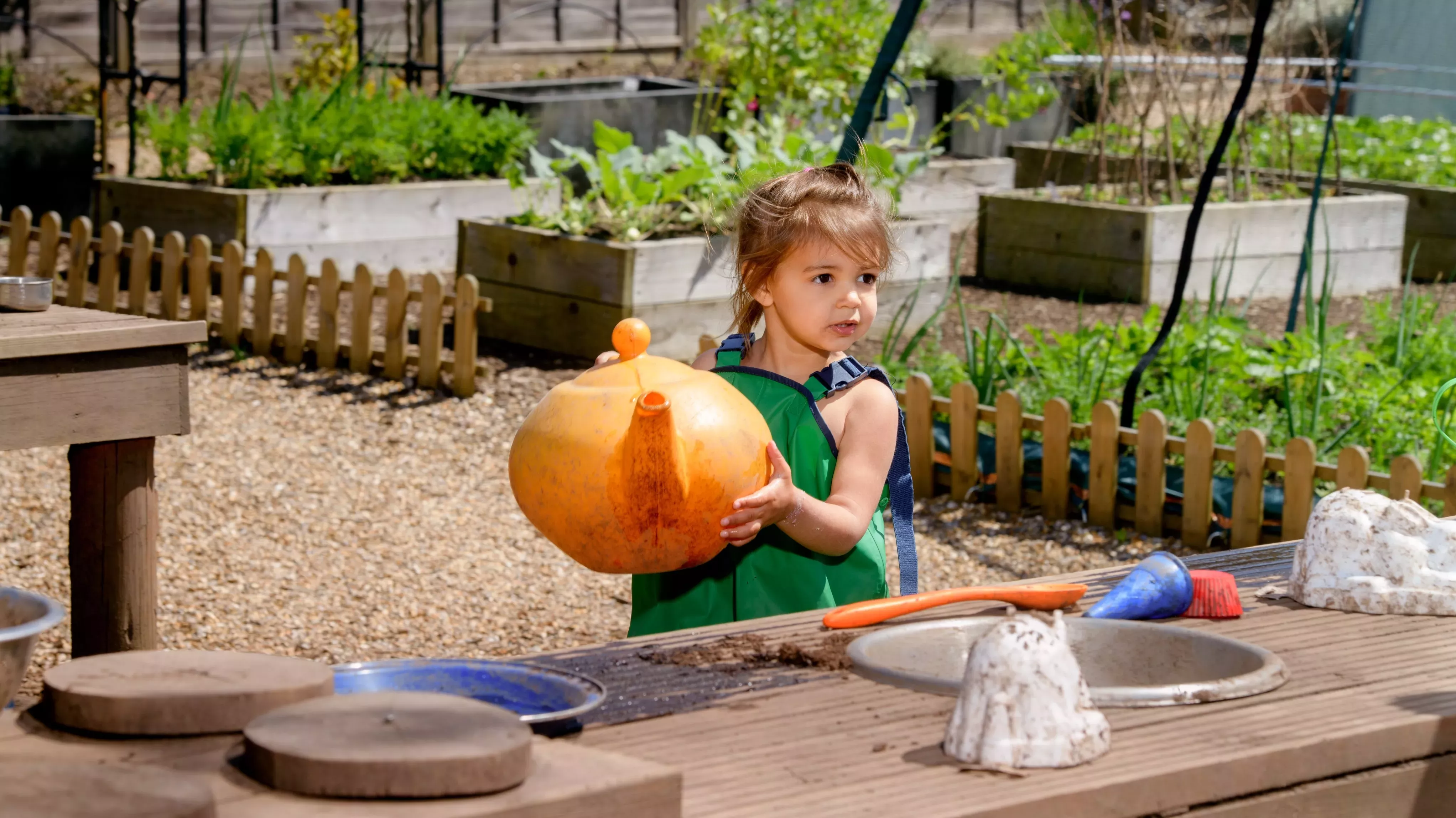 Children play in the mud kitchen