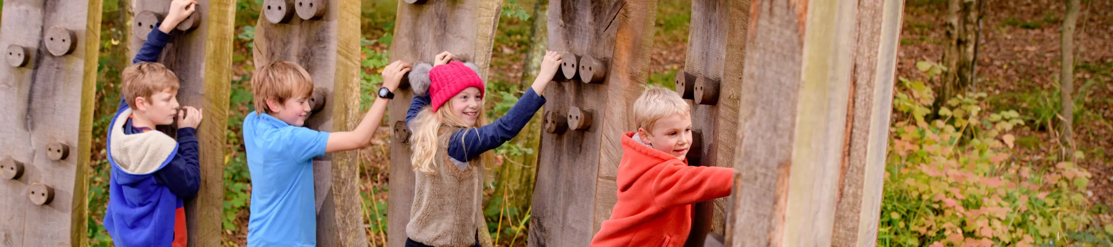 Children climbing on wooden climbing frames