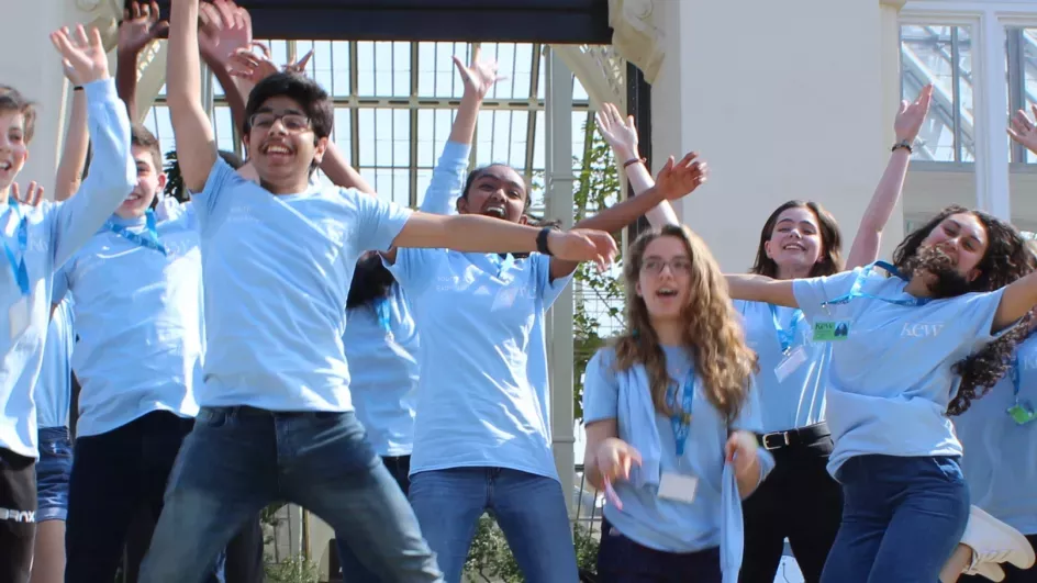 Youth Explainers jumping in the air outside Kew's Temperate House